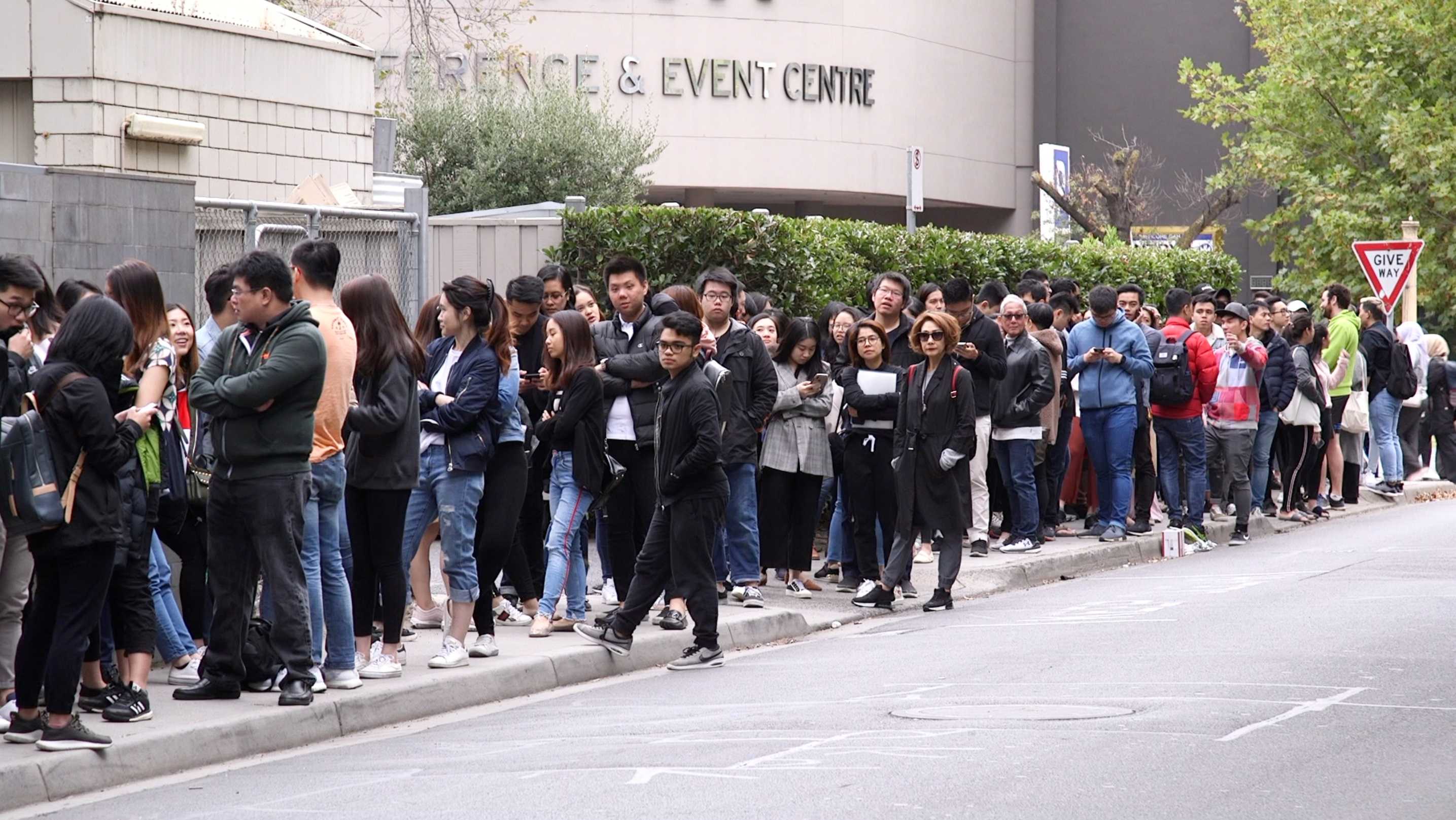 People lining up on the side of road